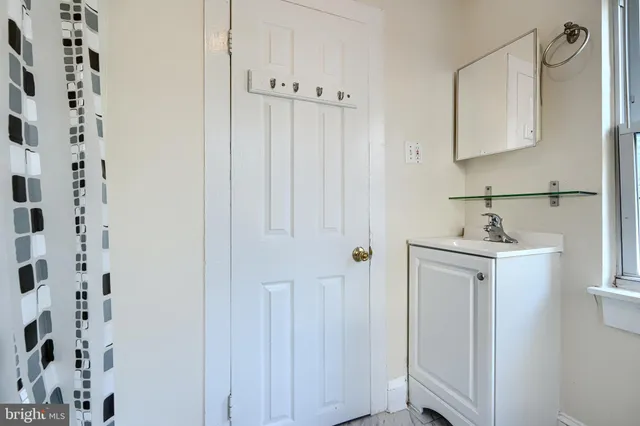 a bathroom with a sink a mirror and shower
