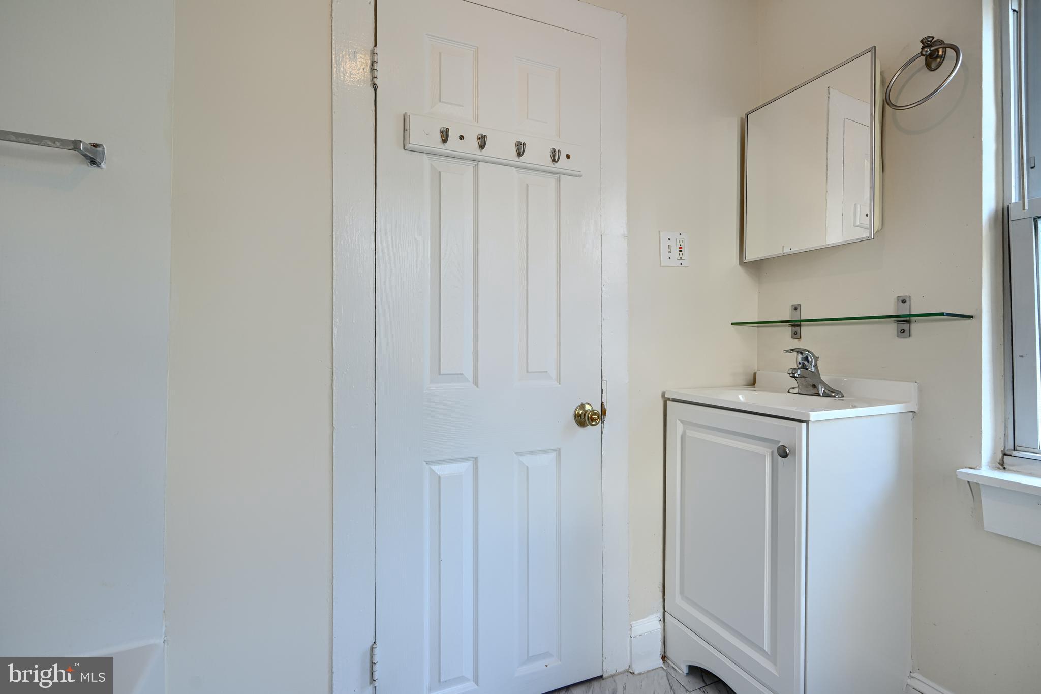 229 South Ann Street, Unit B Baltimore, MD 21231 - Photo 22 of 47 a bathroom with a sink a mirror and shower