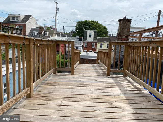 a view of a patio with table and chairs a barbeque