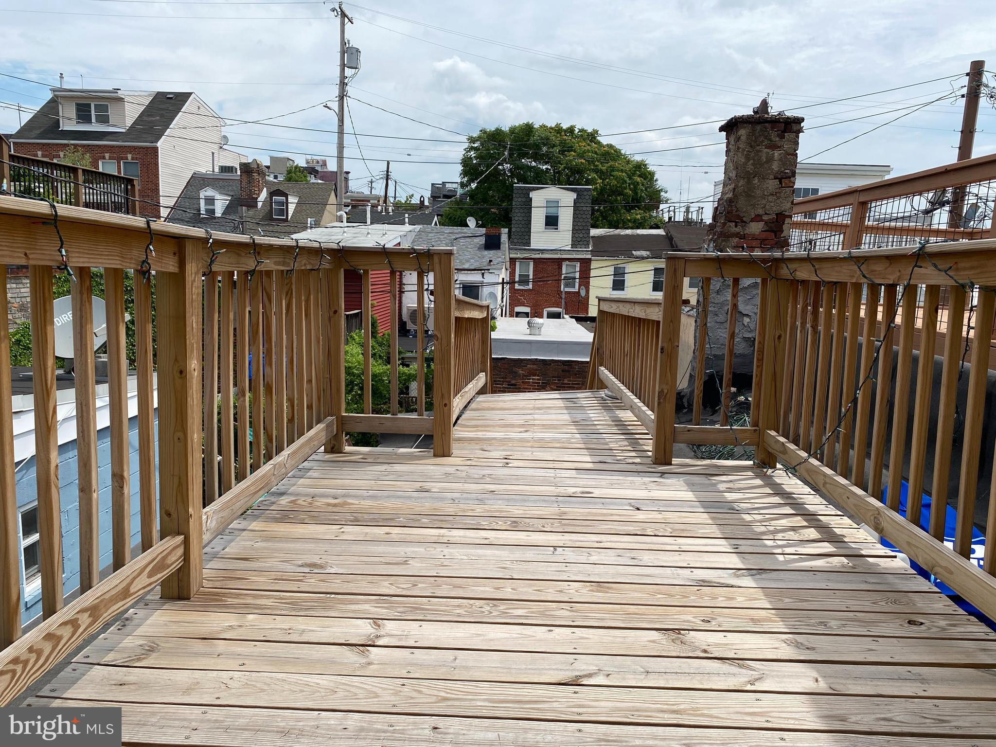 229 South Ann Street, Unit B Baltimore, MD 21231 - Photo 40 of 47 a view of a balcony with wooden floor and outdoor seating