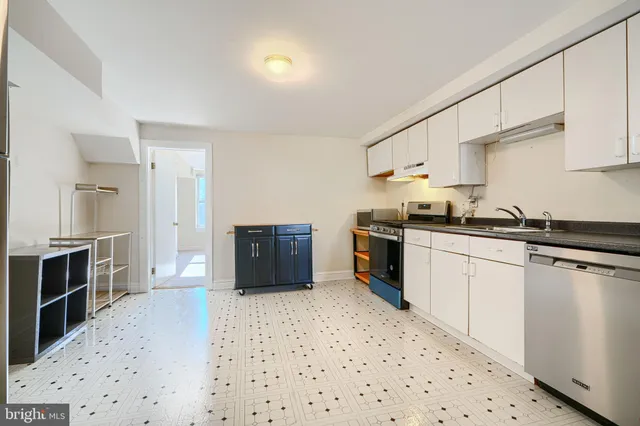 a kitchen with stainless steel appliances a refrigerator and a stove