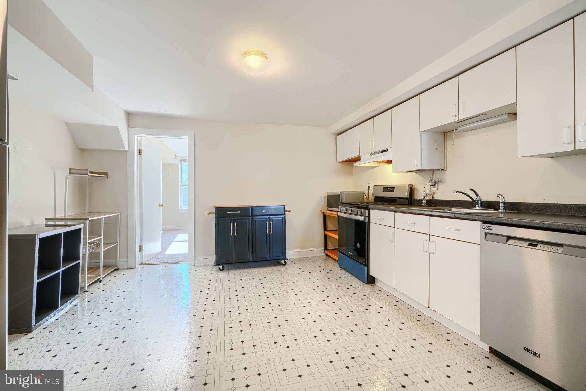 229 South Ann Street, Unit B Baltimore, MD 21231 - Photo 5 of 47 a kitchen with stainless steel appliances a refrigerator and a stove