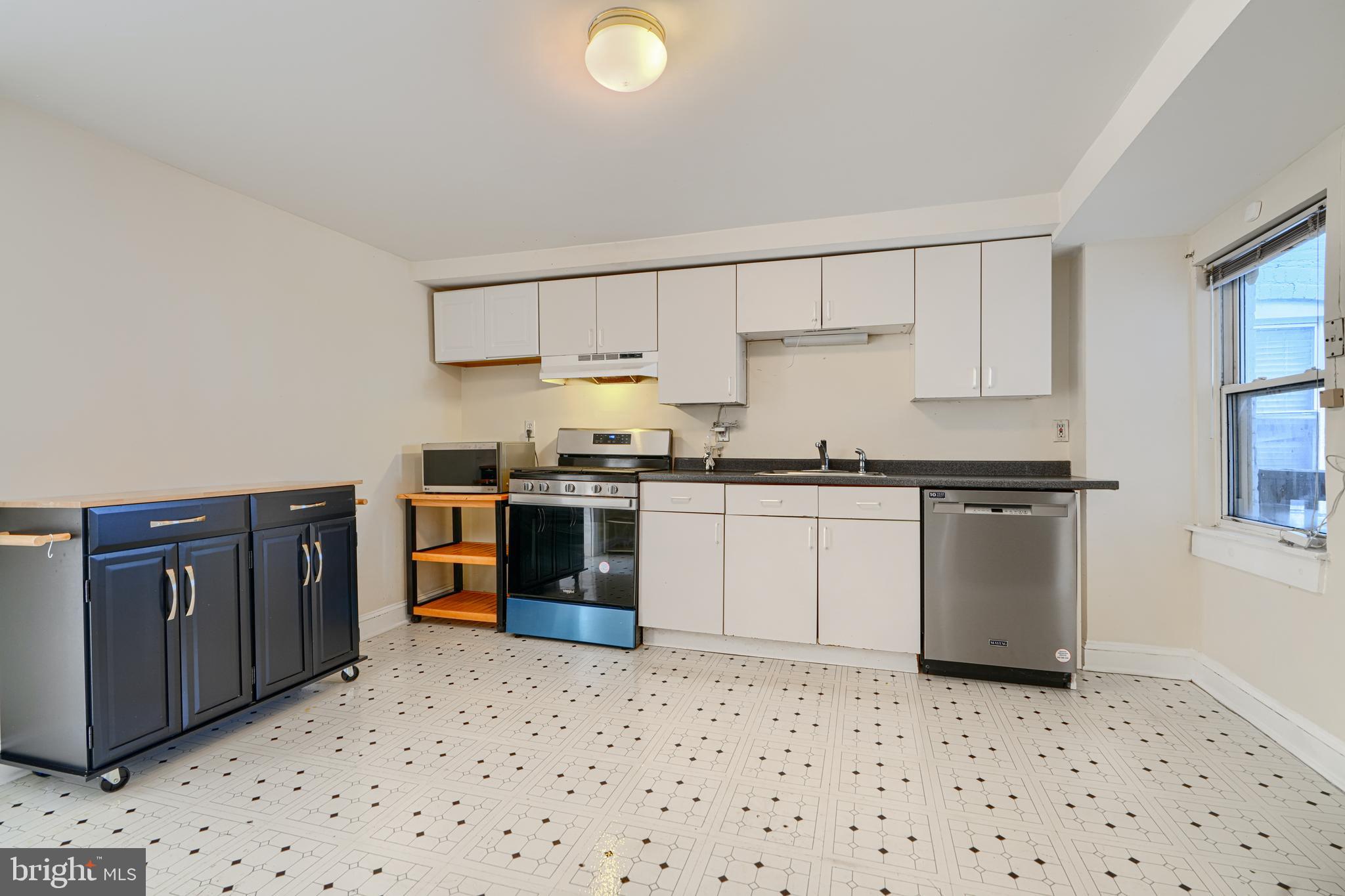 229 South Ann Street, Unit B Baltimore, MD 21231 - Photo 6 of 47 a kitchen with granite countertop a sink and cabinets