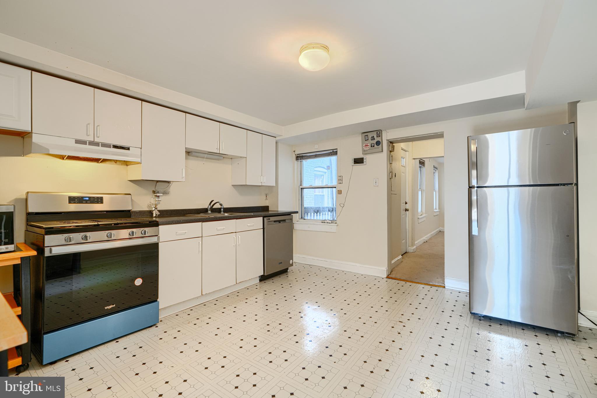 229 South Ann Street, Unit B Baltimore, MD 21231 - Photo 7 of 47 a kitchen with a refrigerator and a stove top oven