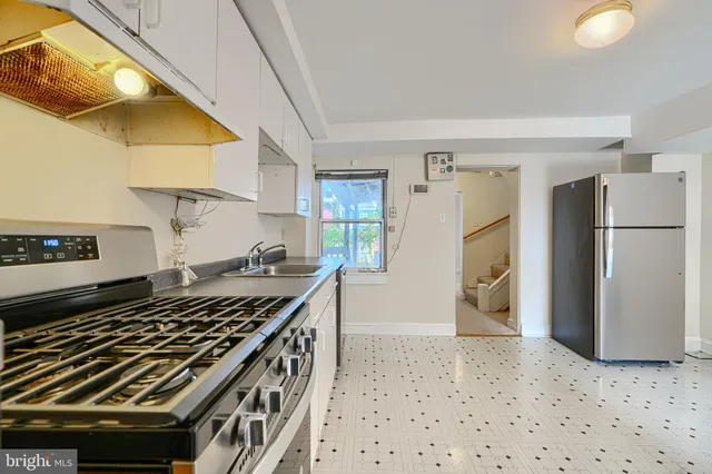 a kitchen with a stove and a refrigerator
