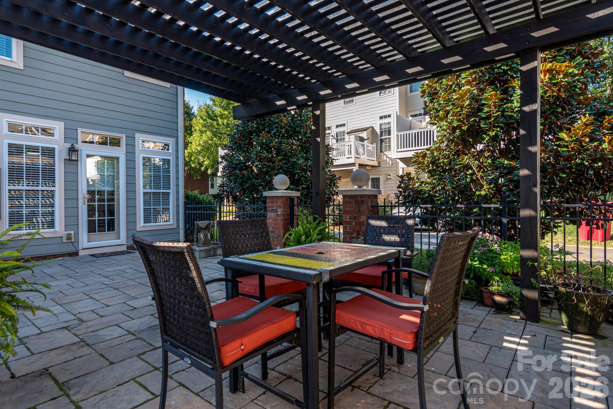 438 Magnolia Street Davidson, NC 28036 - Photo 1 of 20 a view of a patio with table and chairs and potted plants