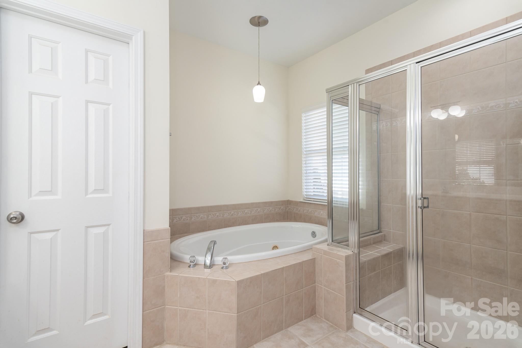 438 Magnolia Street Davidson, NC 28036 - Photo 18 of 20 a white bath tub sitting next to a shower