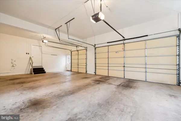 a view of a livingroom with wooden floor and a ceiling fan