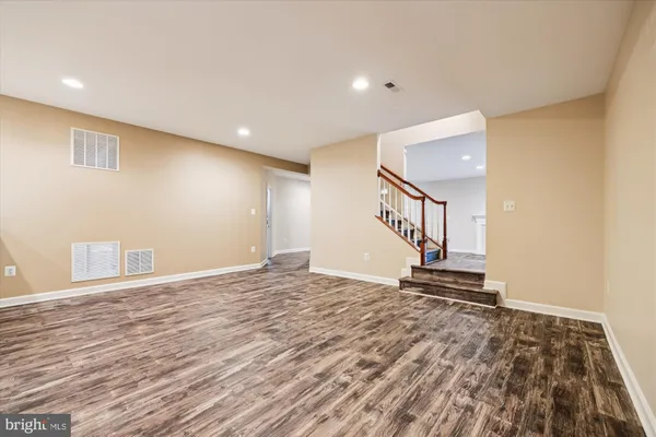 a front view of a house with a garden and plants