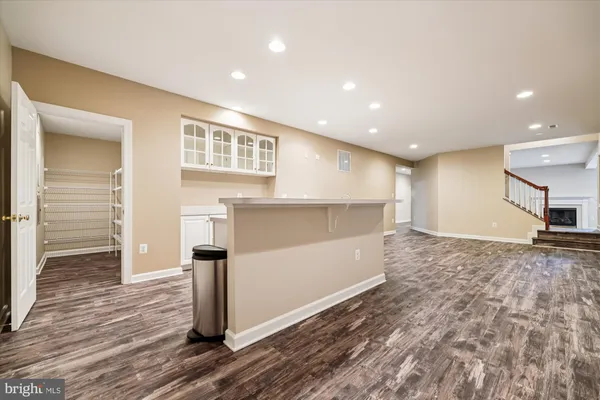 a view of a lake with a bench and trees