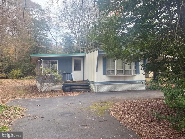 a house that has a tree in front of it