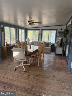 a view of a dining room with furniture wooden floor and chandelier