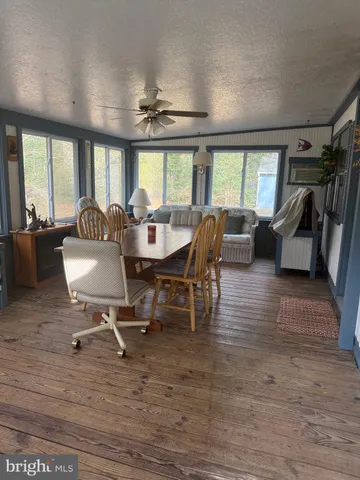 a view of a dining room with furniture wooden floor and chandelier