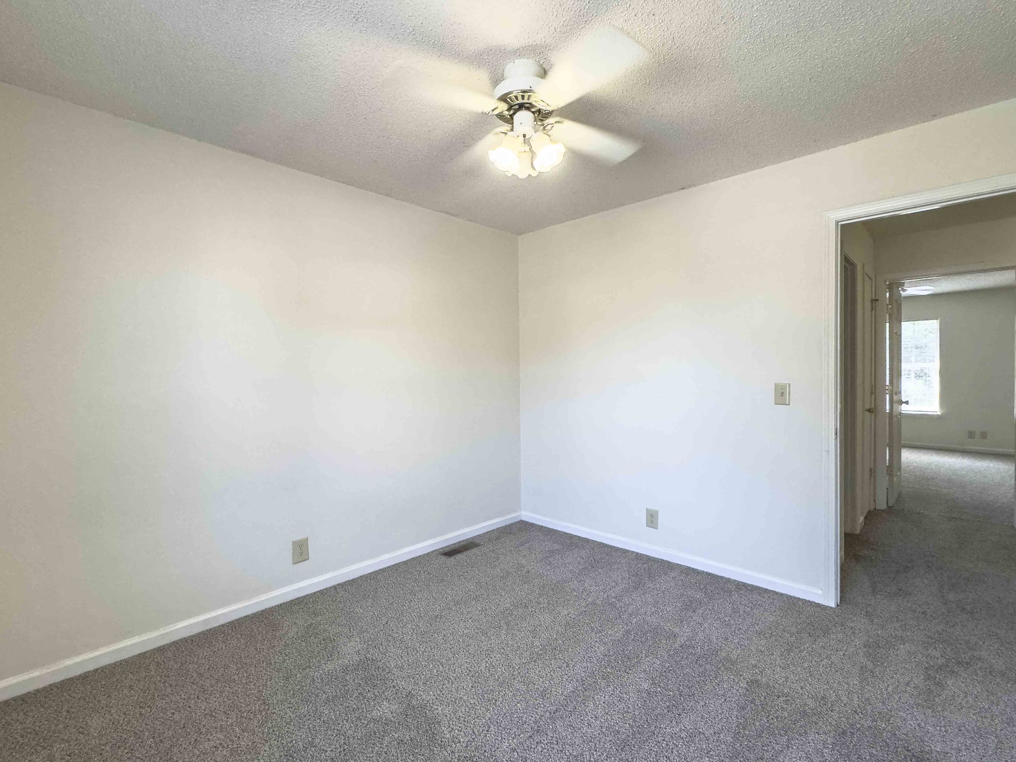 108 Hickory Trace Road, Unit 2 Clarksville, TN 37040 - Photo 15 of 22 an empty room with a chandelier fan and windows