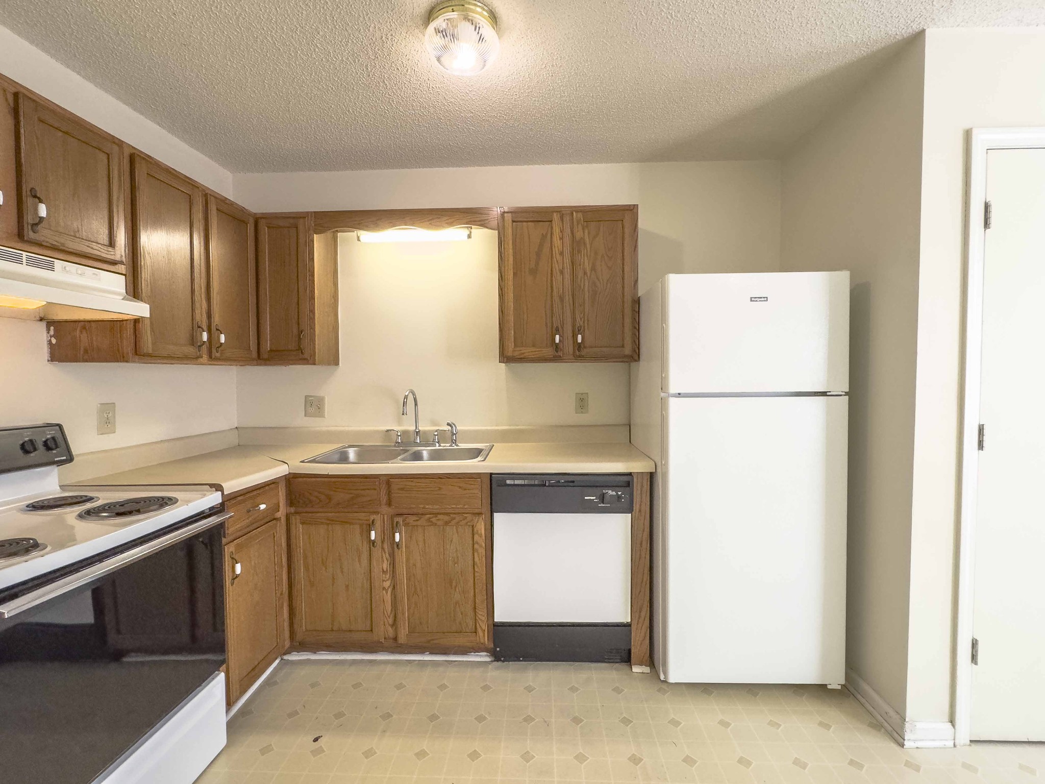 108 Hickory Trace Road, Unit 2 Clarksville, TN 37040 - Photo 7 of 22 a kitchen with a sink a refrigerator and a stove