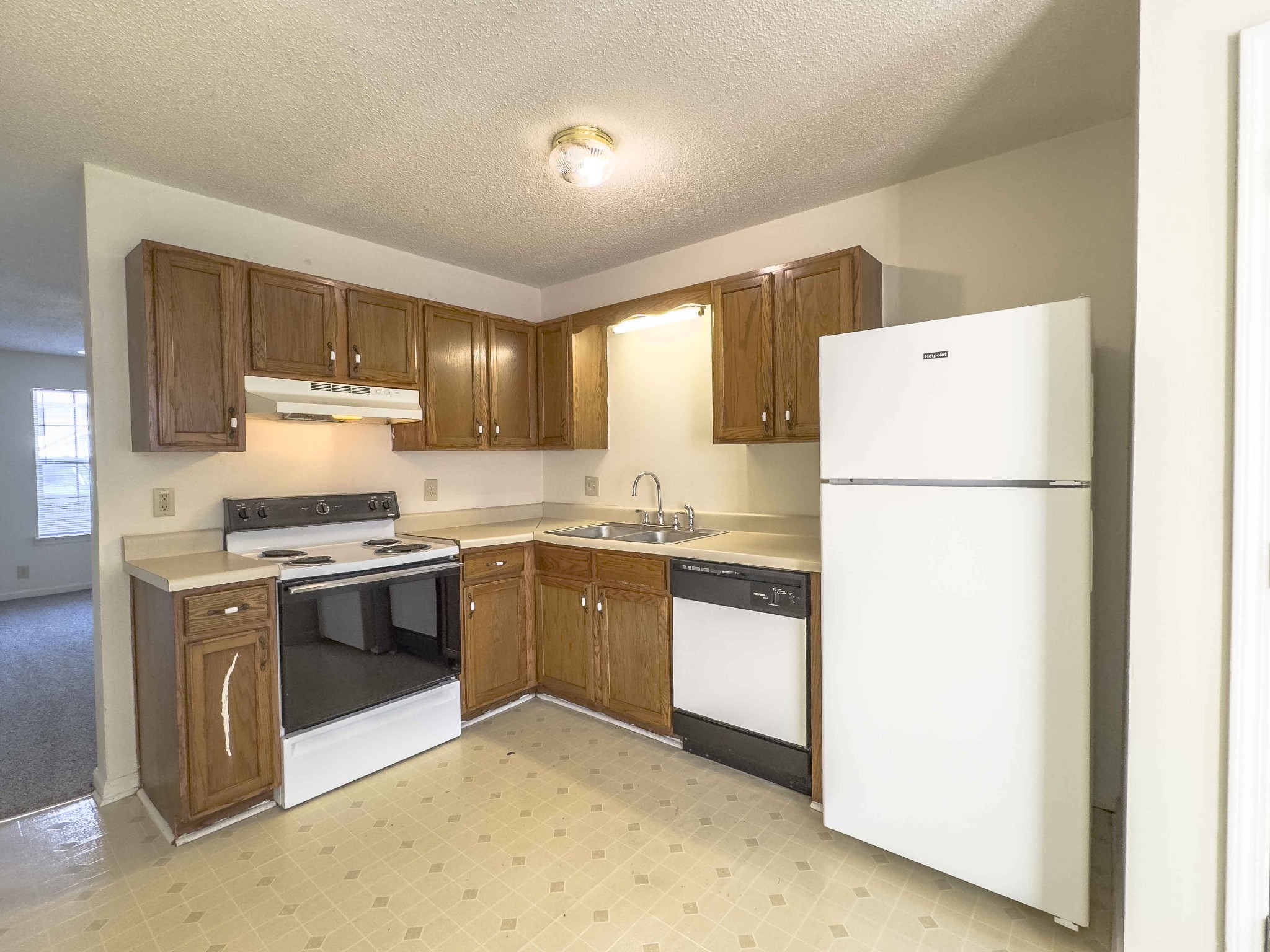 108 Hickory Trace Road, Unit 2 Clarksville, TN 37040 - Photo 8 of 22 a kitchen with a refrigerator sink and white cabinets