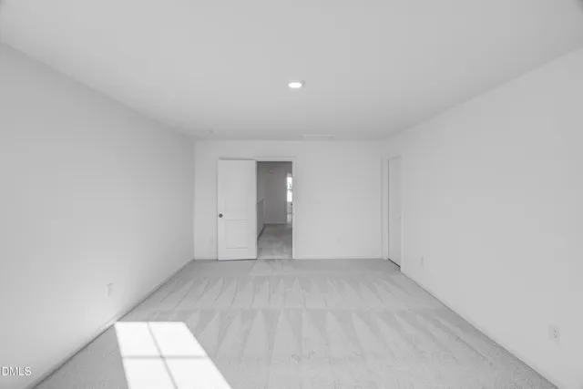 a view of an empty room and closet area