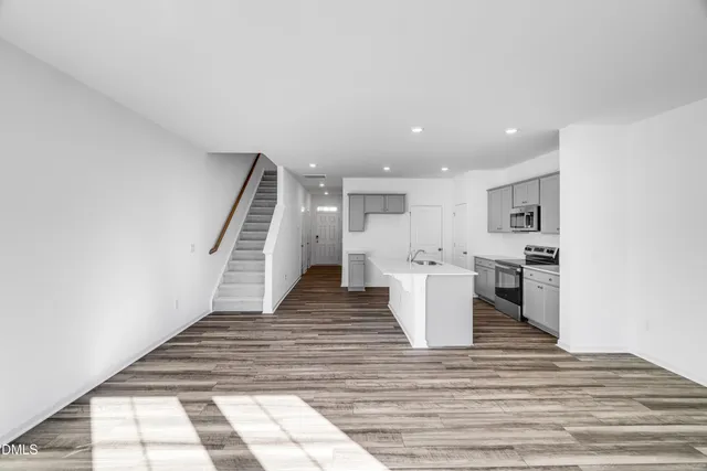a view of kitchen with cabinets and wooden floor