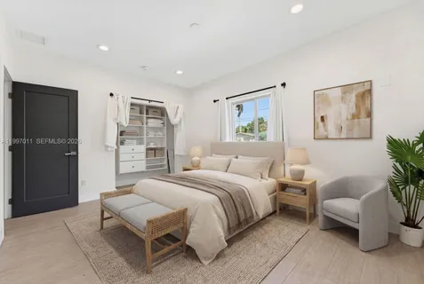 a spacious bedroom with a bed and a couch