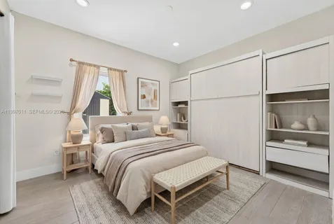 a bedroom with a bed and a window