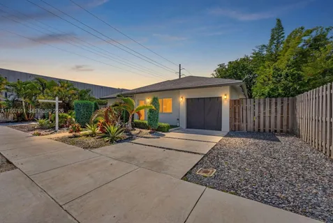 a view of a house with backyard porch and sitting area