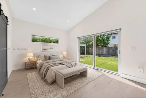 a bedroom with a bed and a large window