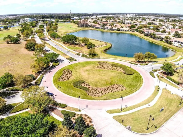 an aerial view of a house with outdoor space swimming pool and lake view