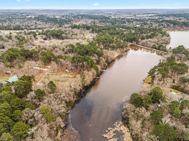 an aerial view of a houses with a lake