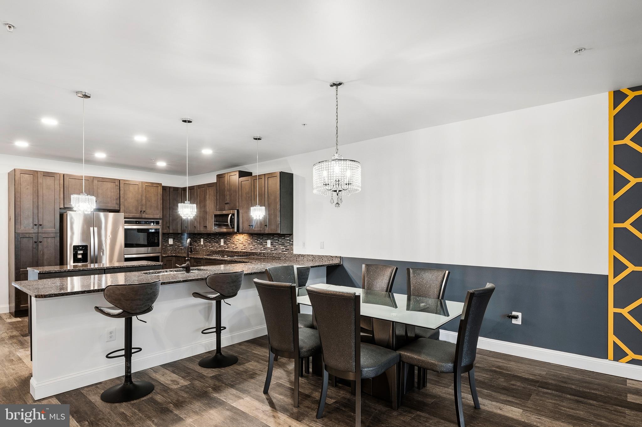 33 Greensborough Road Reisterstown, MD 21136 - Photo 19 of 40 a kitchen with a dining table chairs stainless steel appliances and cabinets