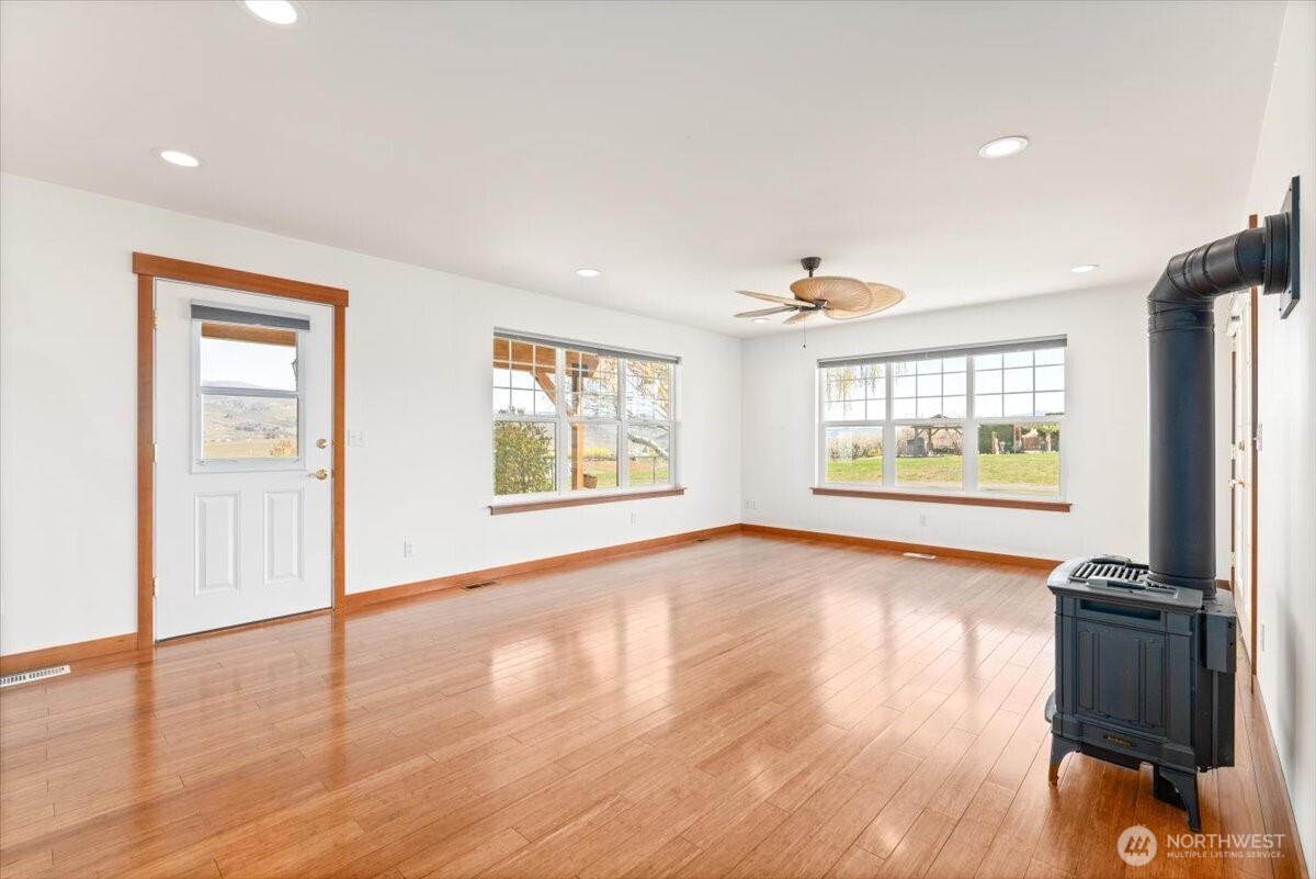 1190 Summit Boulevard Manson, WA 98831 - Photo 12 of 40 a view of an empty room with a window and wooden floor