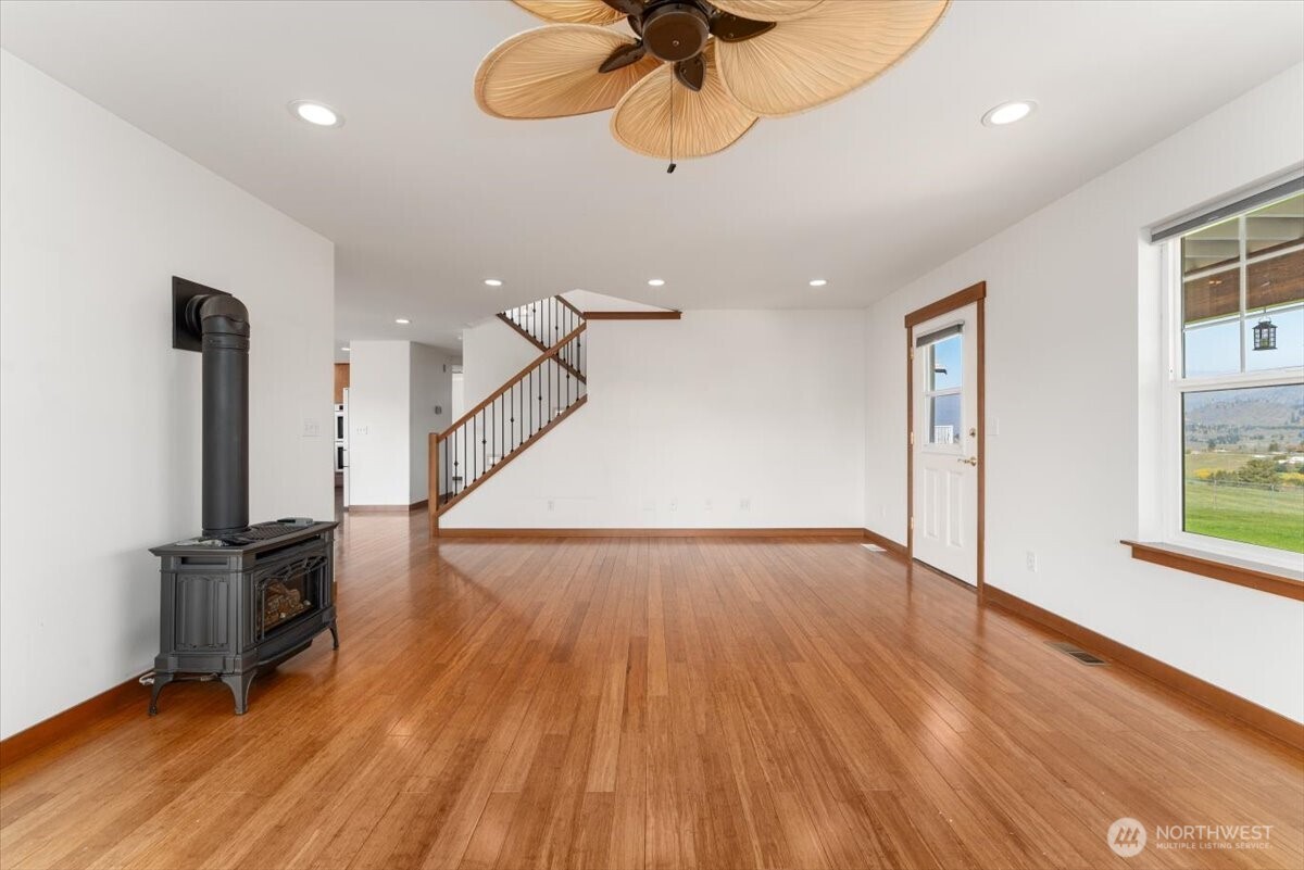 1190 Summit Boulevard Manson, WA 98831 - Photo 13 of 40 a view of an empty room with wooden floor and a window