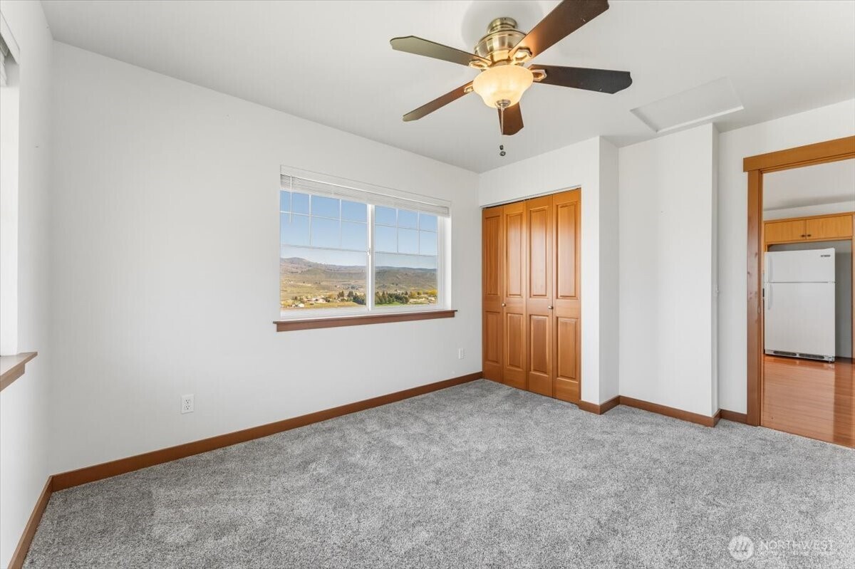 1190 Summit Boulevard Manson, WA 98831 - Photo 33 of 40 an empty room with windows and fan