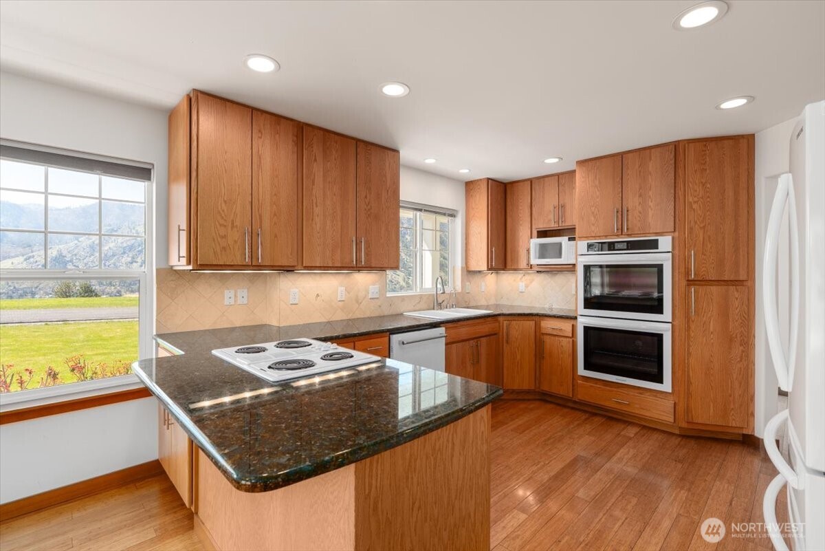 1190 Summit Boulevard Manson, WA 98831 - Photo 9 of 40 a kitchen with a stove a sink and a microwave