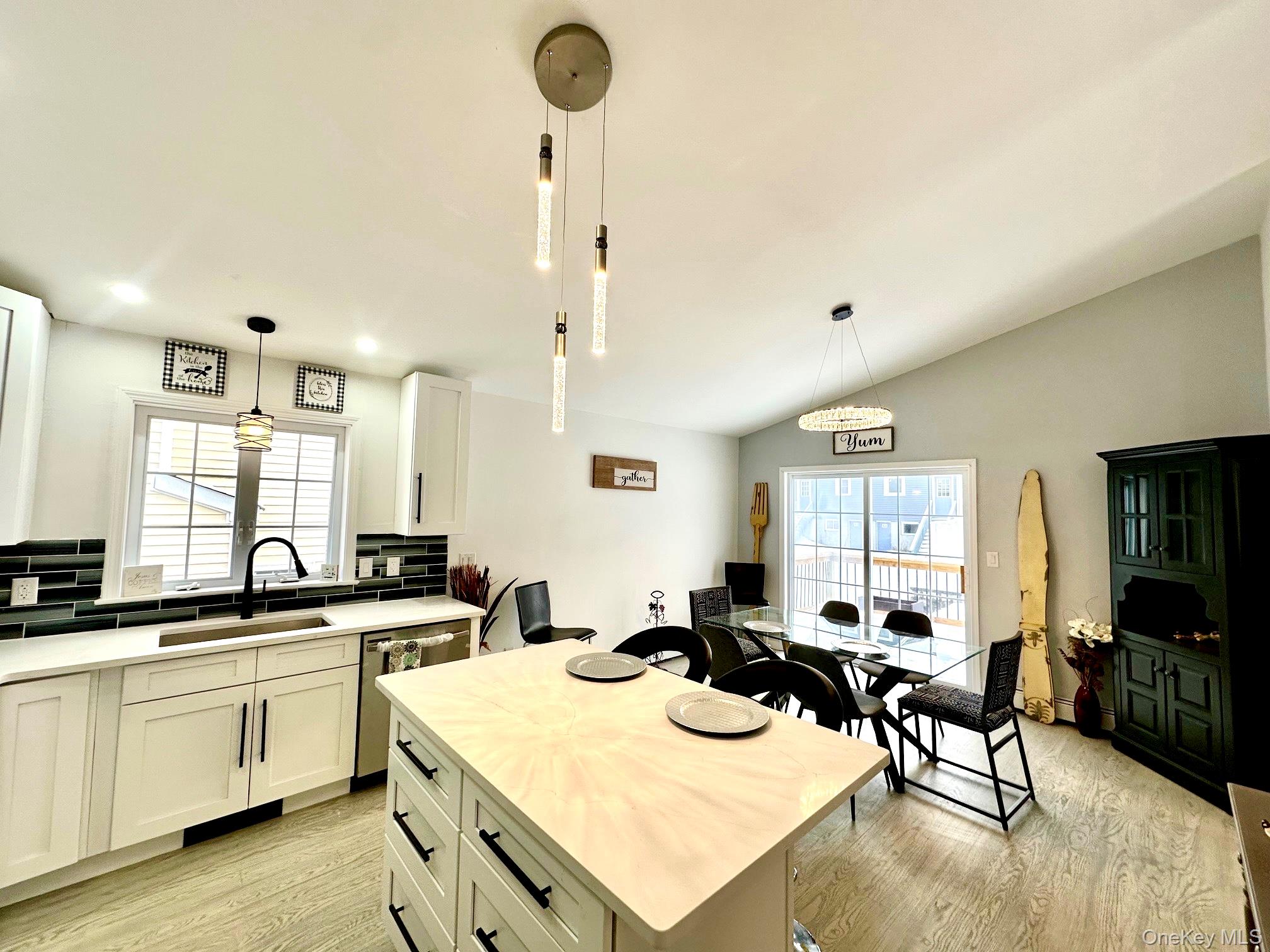 25 Clinton Street Middletown, NY 10940 - Photo 11 of 36 a kitchen with a sink a stove and chairs with wooden floor