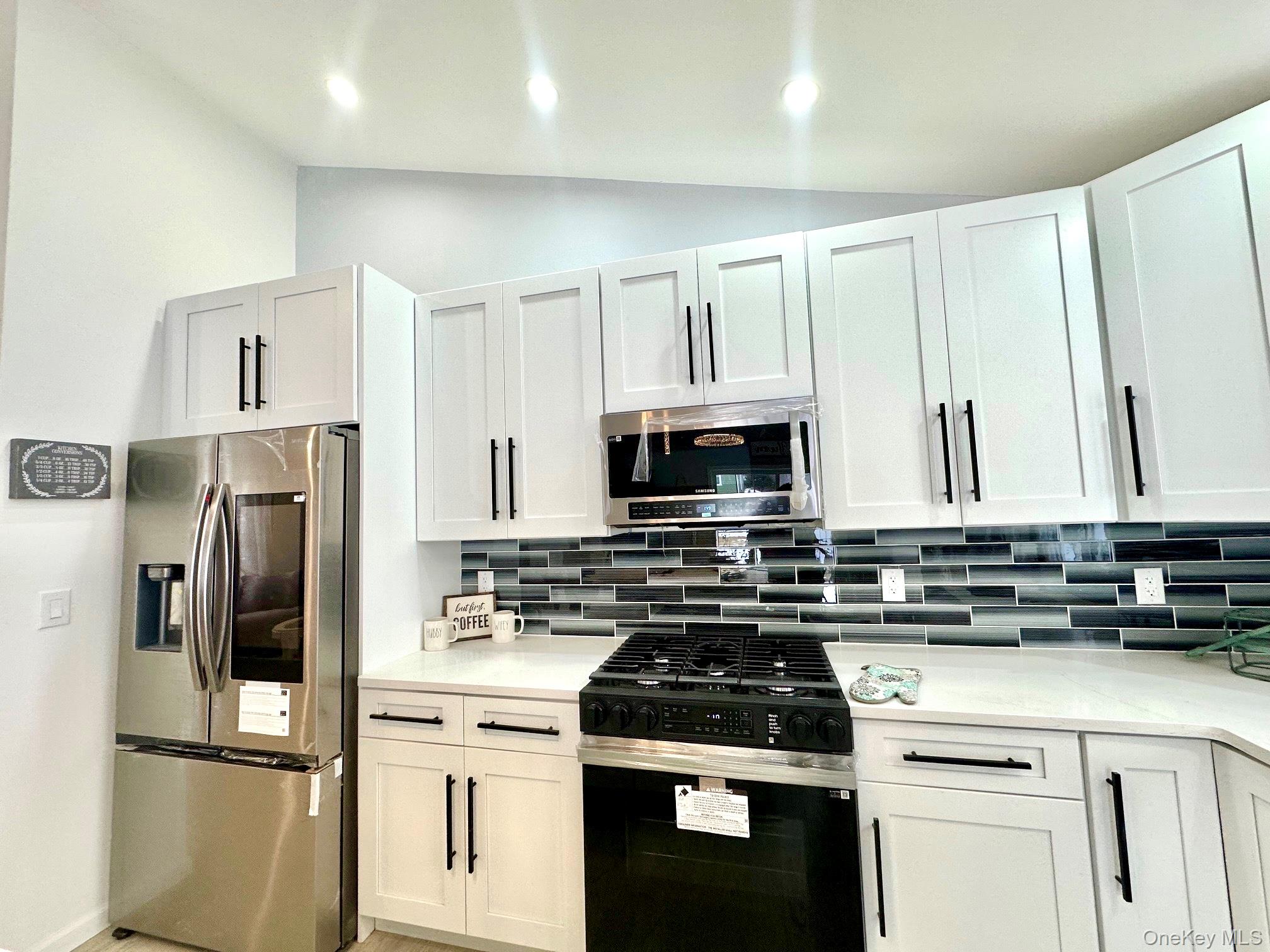 25 Clinton Street Middletown, NY 10940 - Photo 12 of 36 a kitchen with stainless steel appliances a refrigerator stove and microwave