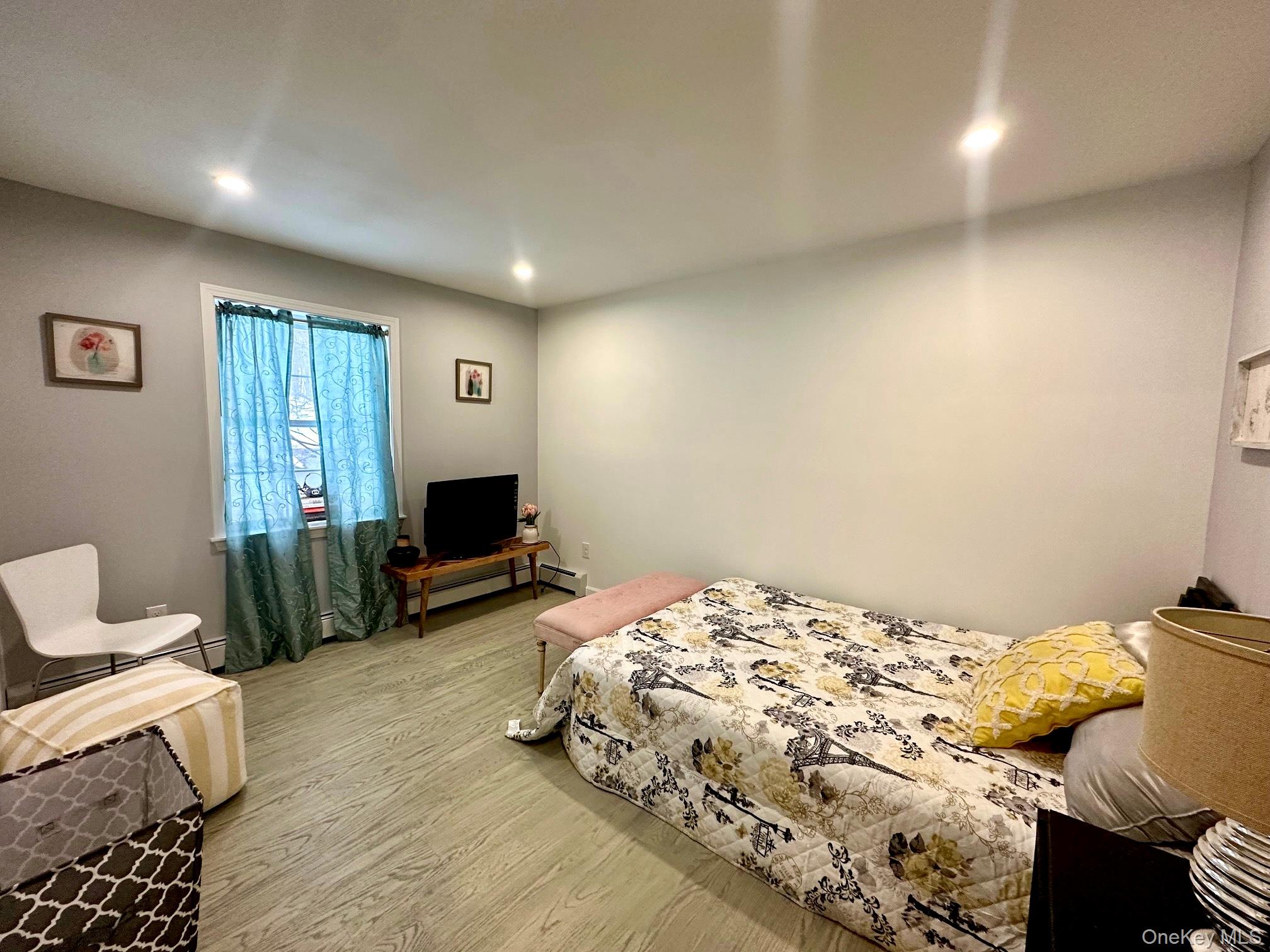 25 Clinton Street Middletown, NY 10940 - Photo 17 of 36 a bedroom with a bed and wooden floor