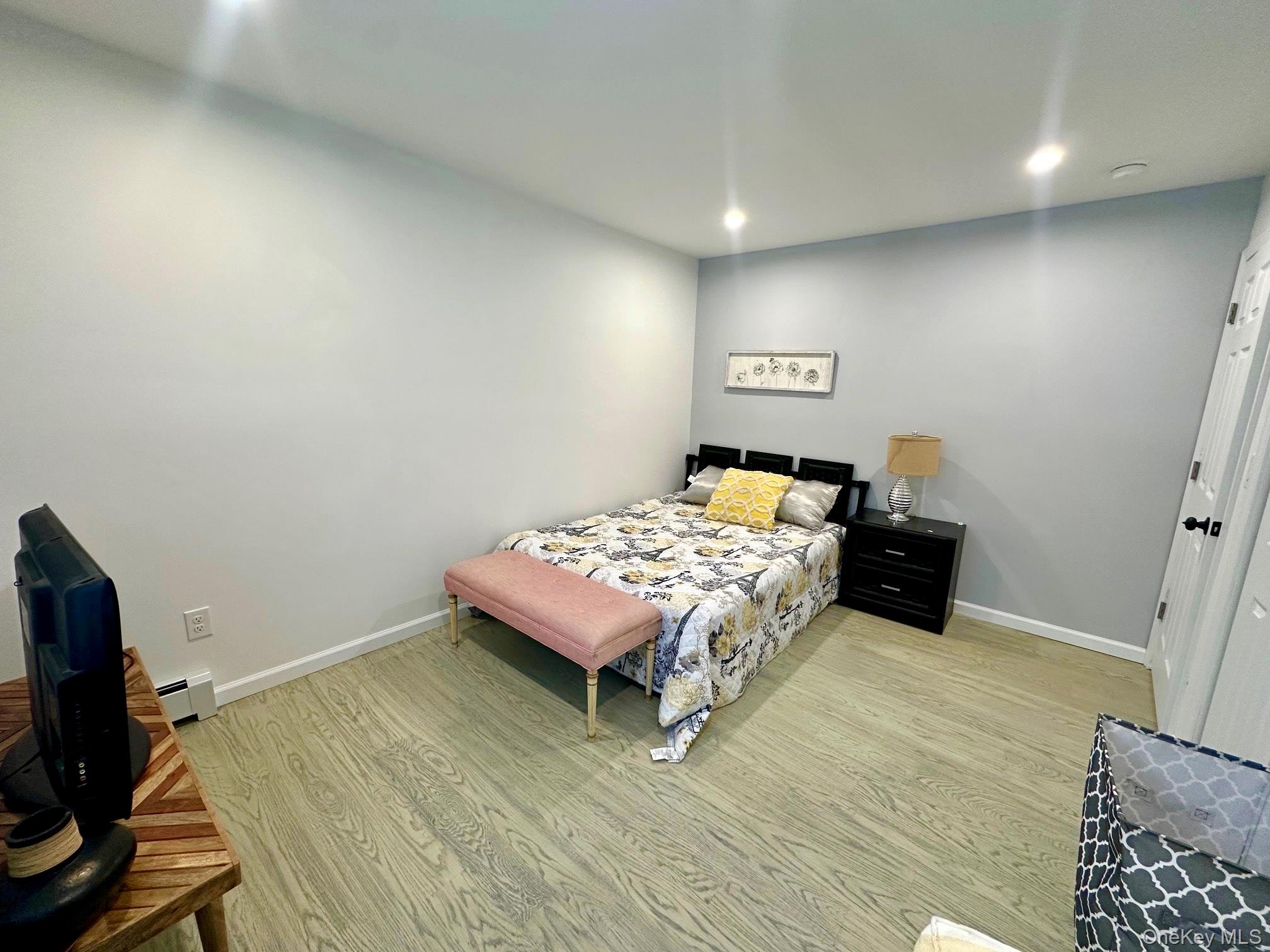 25 Clinton Street Middletown, NY 10940 - Photo 18 of 36 a bedroom with a bed and wooden floor