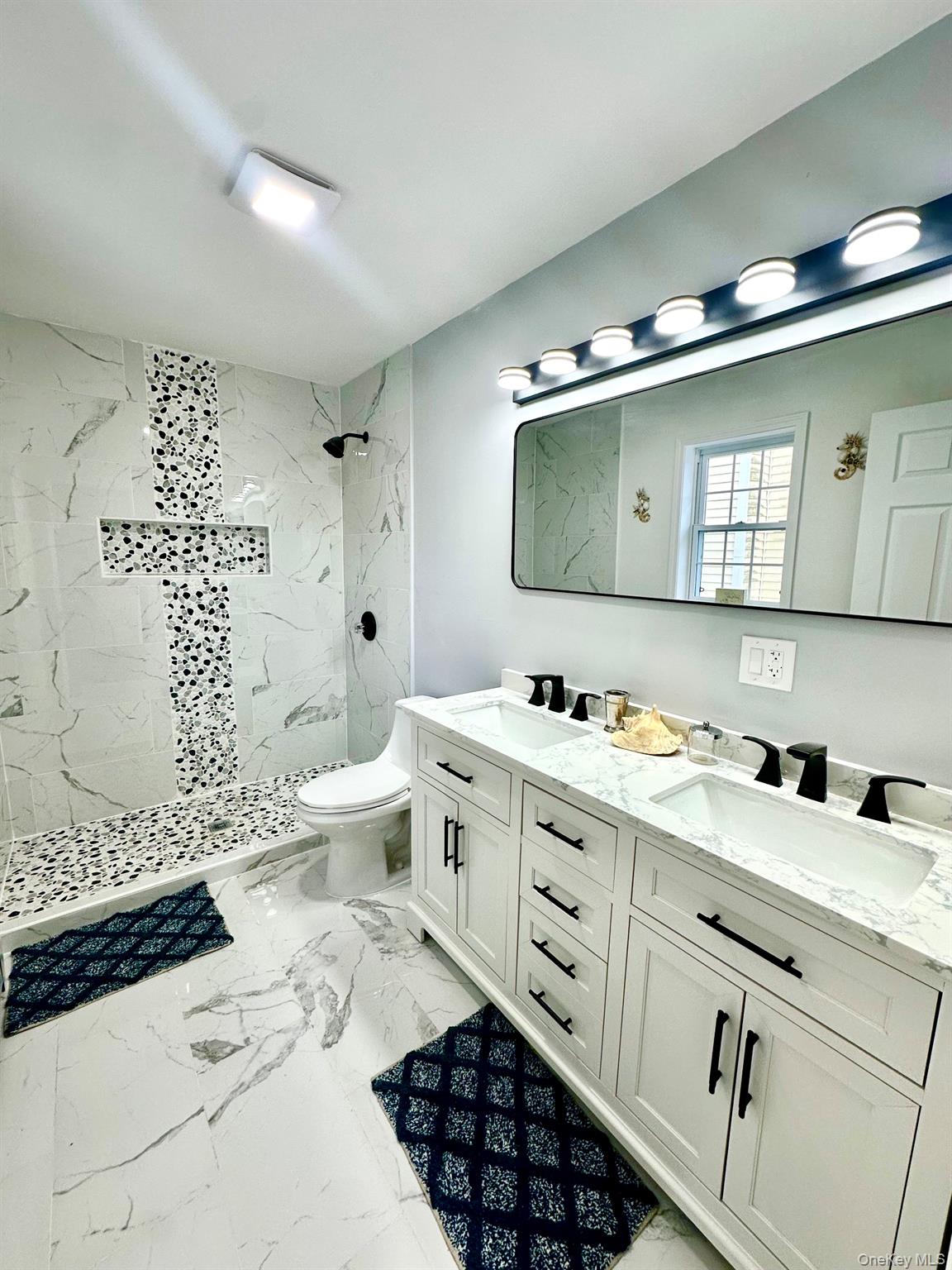 25 Clinton Street Middletown, NY 10940 - Photo 22 of 36 a spacious bathroom with a double vanity sink toilet and shower