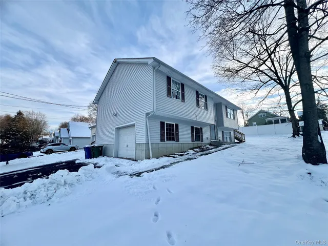 a view of a house with a snow in the yard