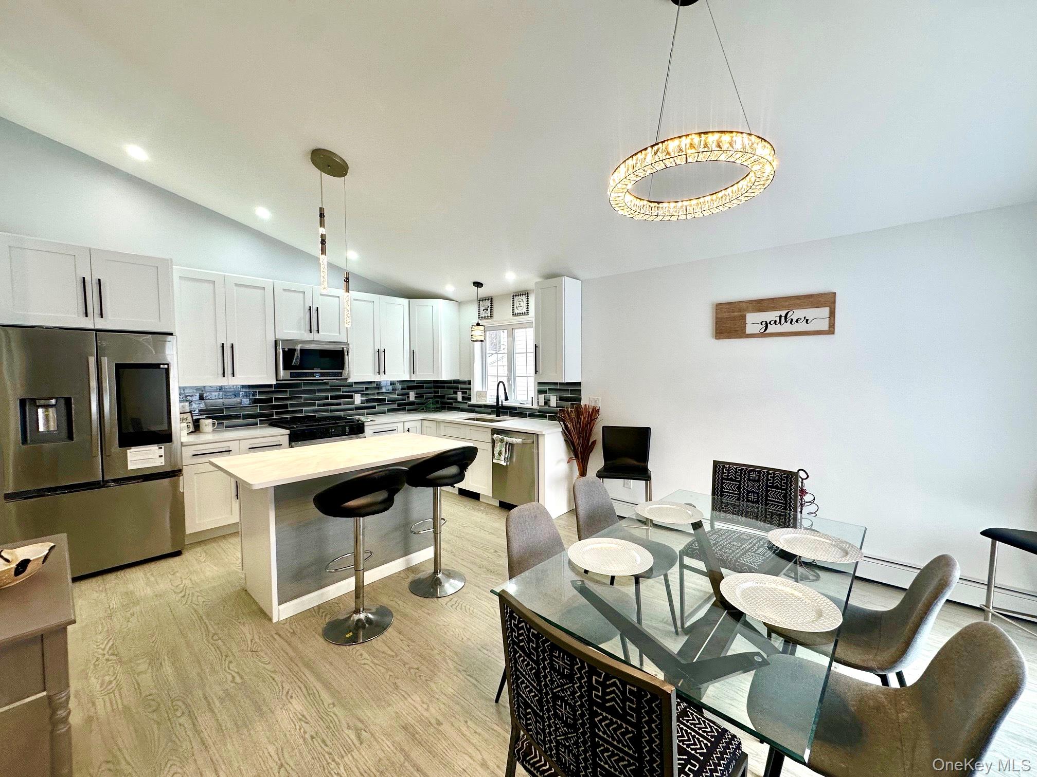 25 Clinton Street Middletown, NY 10940 - Photo 8 of 36 a kitchen with a table chairs microwave and cabinets