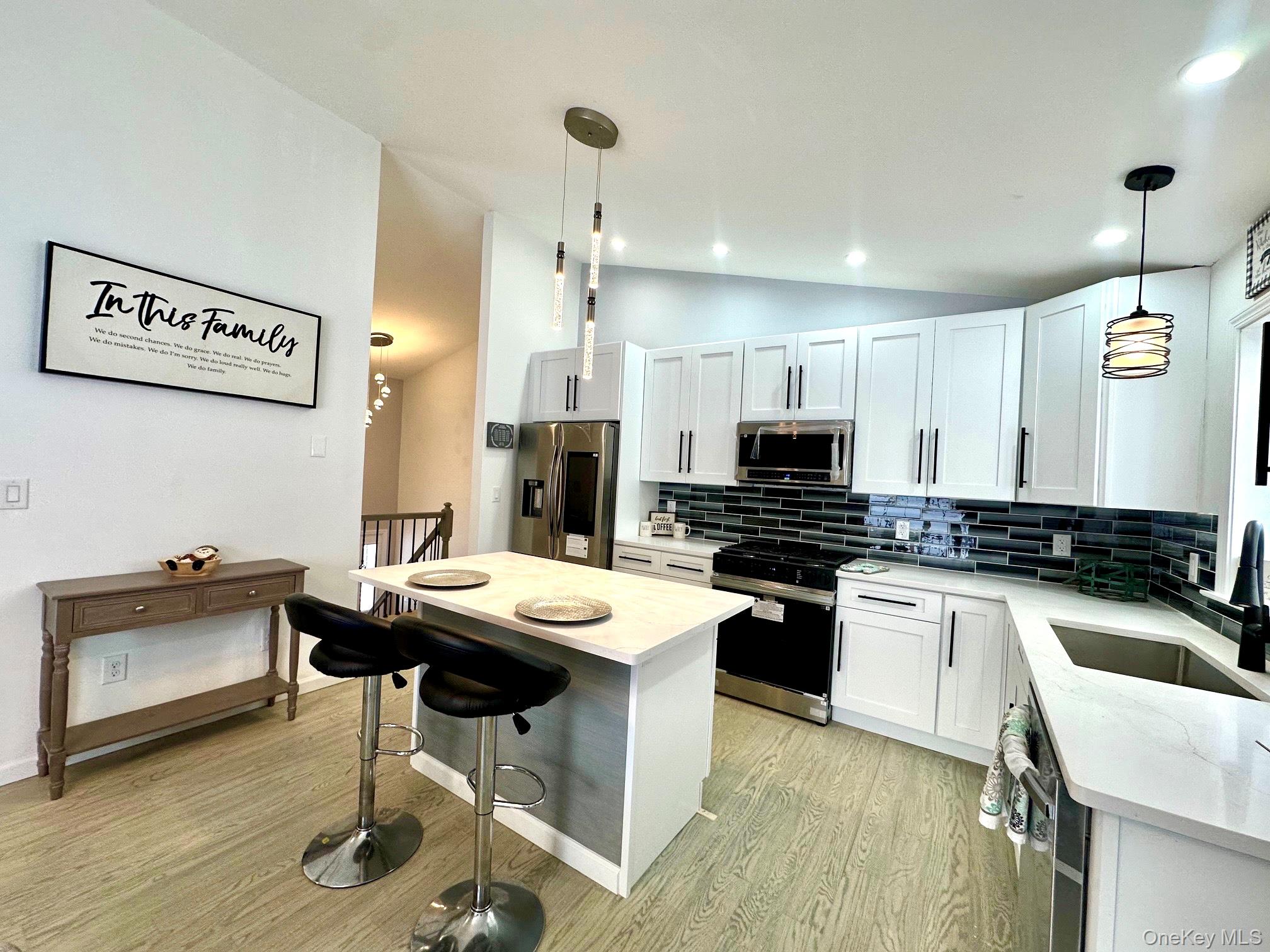 25 Clinton Street Middletown, NY 10940 - Photo 9 of 36 a kitchen with a sink a stove and chairs