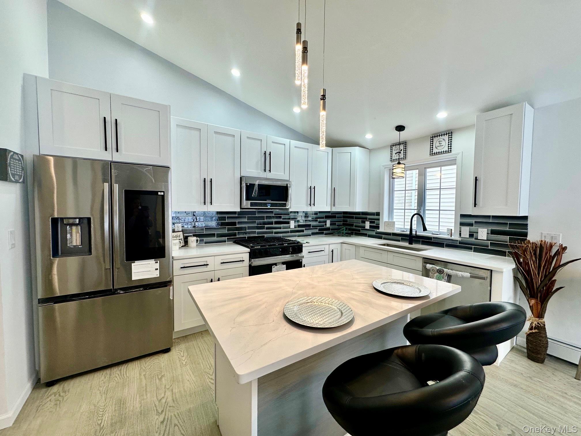 25 Clinton Street Middletown, NY 10940 - Photo 10 of 36 a kitchen with stainless steel appliances granite countertop a sink a stove a refrigerator and white cabinets