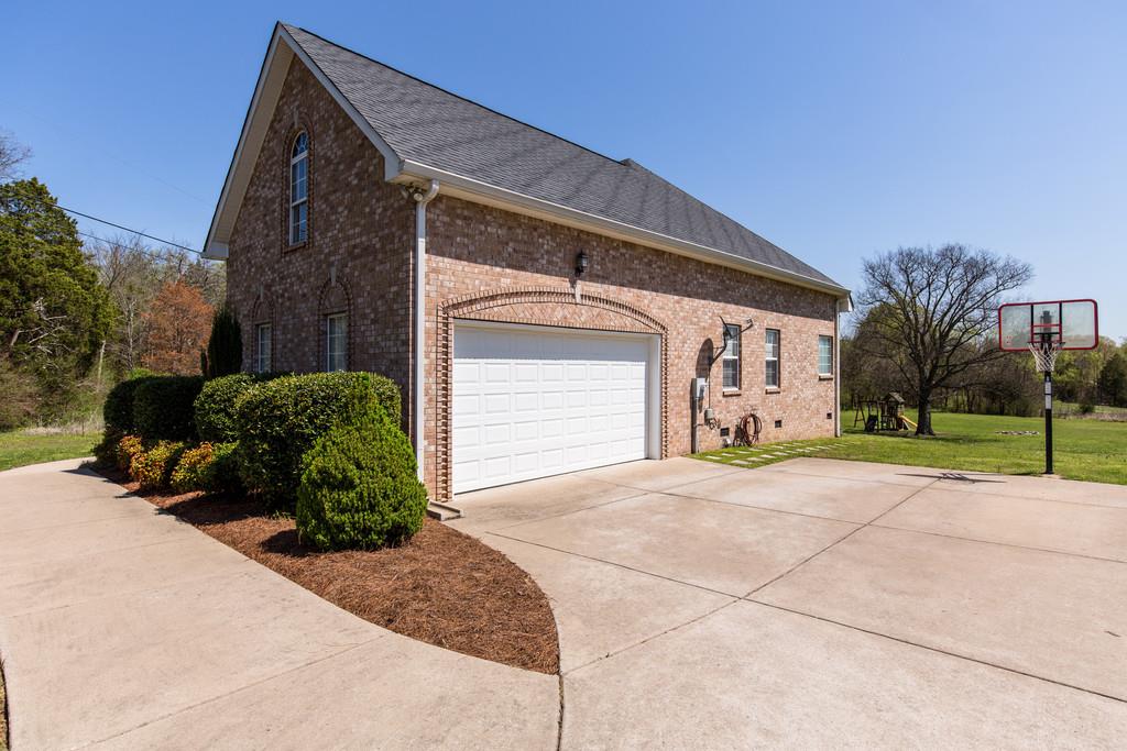 501 Sugar Flat Road Lebanon, TN 37087 - Photo 3 of 16 a front view of a house with garden and parking