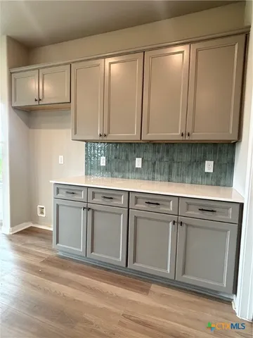 a kitchen with granite countertop a cabinets sink and white appliances