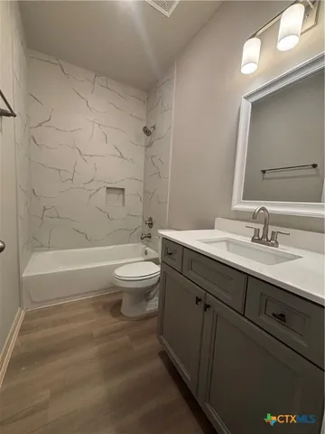 a bathroom with a double vanity sink toilet and shower