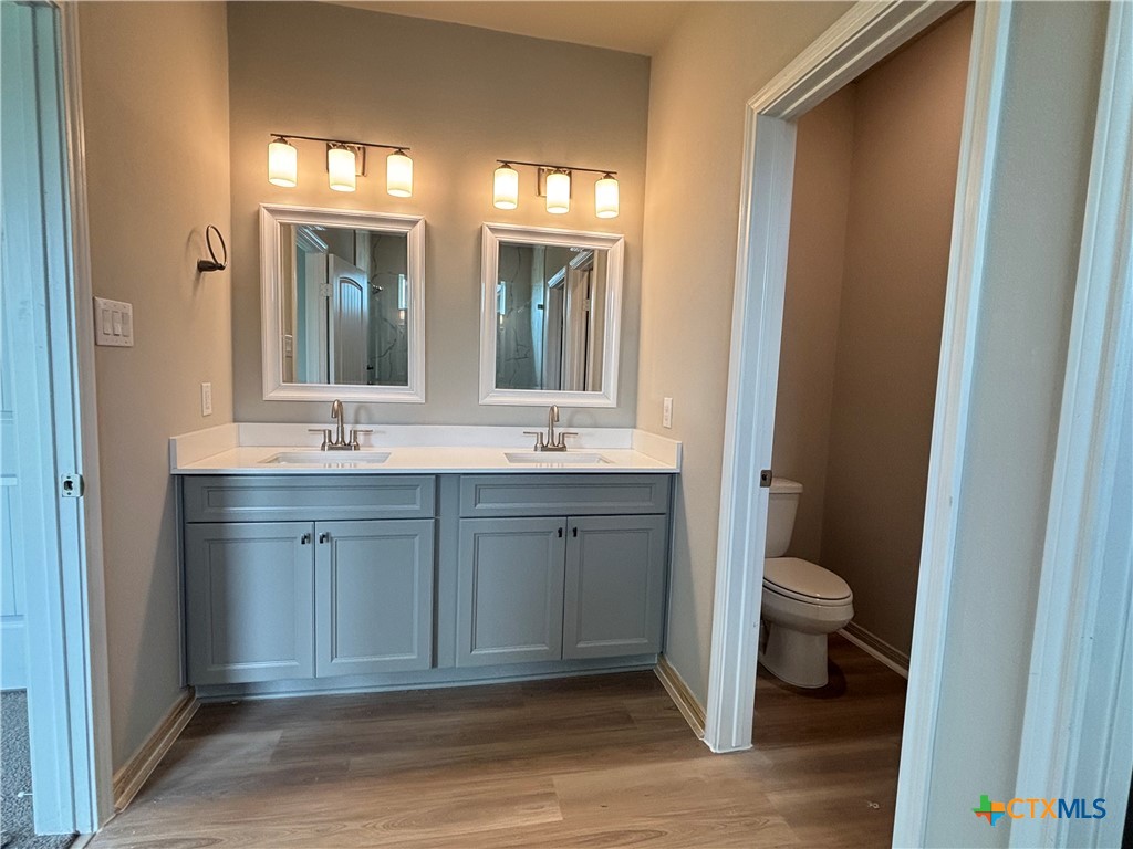 837 Swallow Drive Palacios, TX 77465 - Photo 24 of 35 a bathroom with a granite countertop sink toilet and mirror