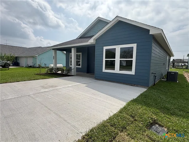 a view of a house with a yard and garage