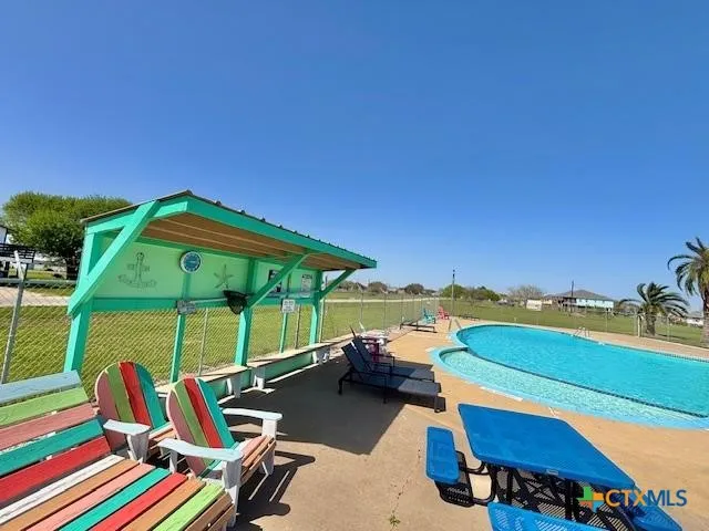 a view of a backyard with a table and chairs