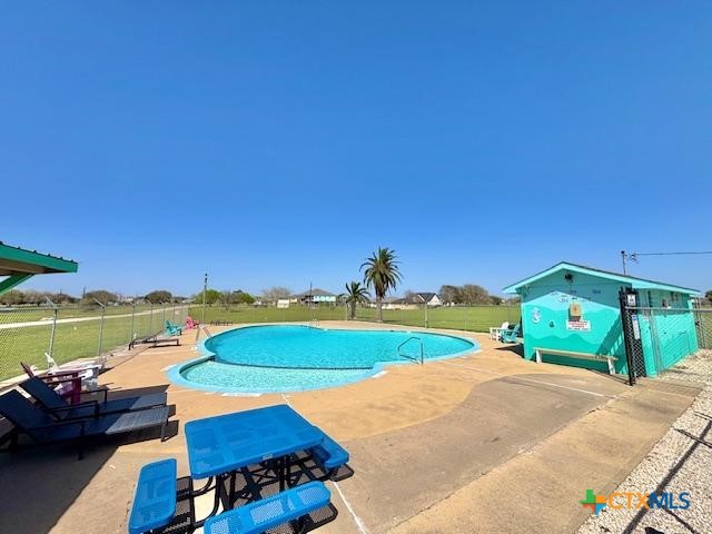 837 Swallow Drive Palacios, TX 77465 - Photo 32 of 35 a view of a backyard with a table and chairs