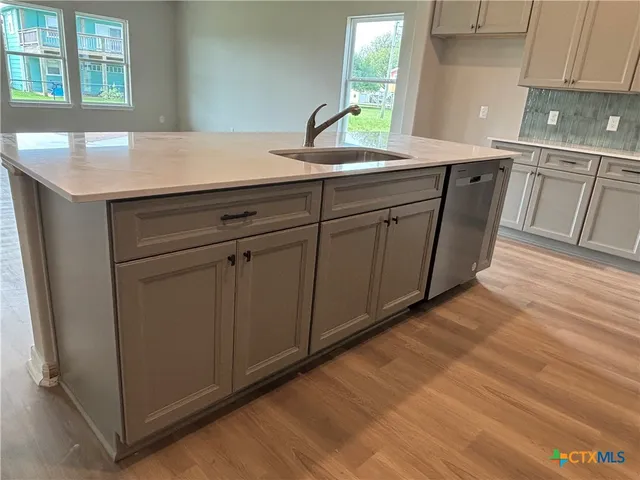 a kitchen with a sink and cabinets